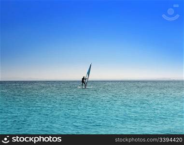 windsurfing - surfer on blue sea under sky