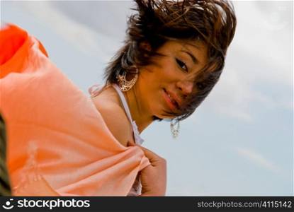 Windswept woman with orange shawl