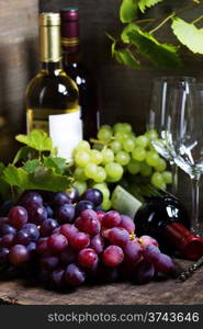 Wine and grape on wooden background