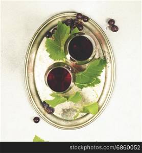 Wine and grapes over grey marble background, top view, copy space