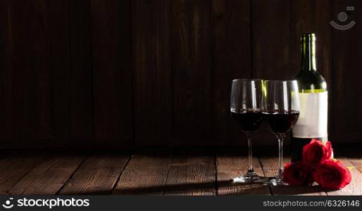 Wine and roses. Two glasses and bottle of red wine, roses, Valentine day