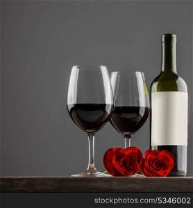 Wine and roses. Two glasses of red wine and heart shaped roses, Valentine day