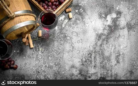 Wine background. A barrel with red wine and fresh grapes. On a rustic background.. Wine background. A barrel with red wine and fresh grapes.