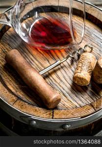 Wine background. A glass of red wine on an old barrel. On a wooden background.. Wine background. A glass of red wine on an old barrel.