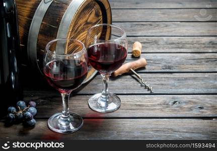 Wine background. An old barrel of red wine. On a wooden background.. Wine background. An old barrel of red wine.