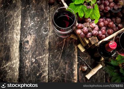 Wine background. Red wine with a box of grapes. On a wooden background.. Wine background. Red wine with a box of grapes.