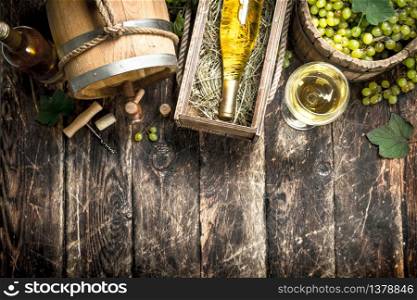 Wine background. White wine with a bucket of green grapes. On a wooden background.. Wine background. White wine with a bucket of green grapes.
