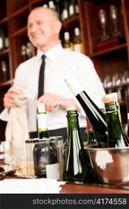 Wine bar bottles close-up waiter clean glass in restaurant