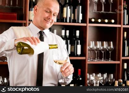 Wine bar happy waiter pour white wine in glass restaurant