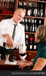 Wine bar professional waiter serve glass senior woman smiling