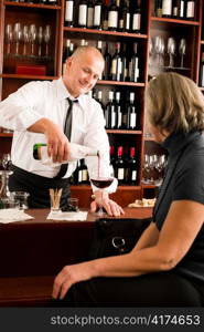 Wine bar professional waiter serve glass senior woman smiling