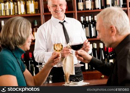 Wine bar senior couple enjoy drink professional barman pour glass