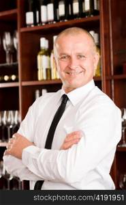 Wine bar waiter male in restaurant posing with cross arms