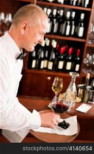 Wine bar waiter mature serving on tray glass olives restaurant