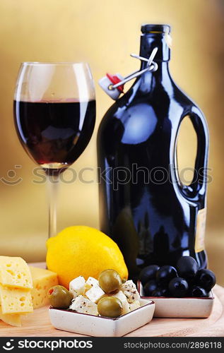 wine bottle and cheese on gold background