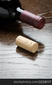Wine Bottle and Cork on a Reflective Wood Surface Abstract.