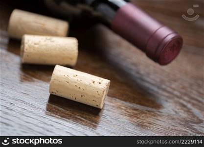 Wine Bottle and Corks on a Reflective Wood Surface Abstract.