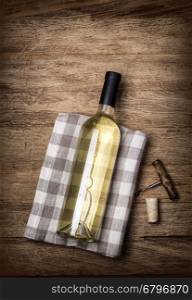 wine bottle and corkscrew on wooden table background. Top view with copy space