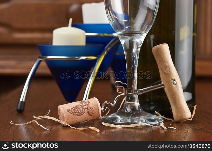 wine bottle and wineglass on a wooden table