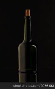 Wine bottle on a black background. Soft beautiful highlights on the bottle, with reflection.. Wine bottle on a black background. Soft beautiful highlights on the bottle.