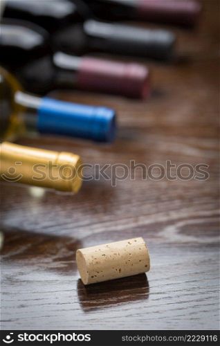 Wine Bottles and Cork on a Reflective Wood Surface Abstract.