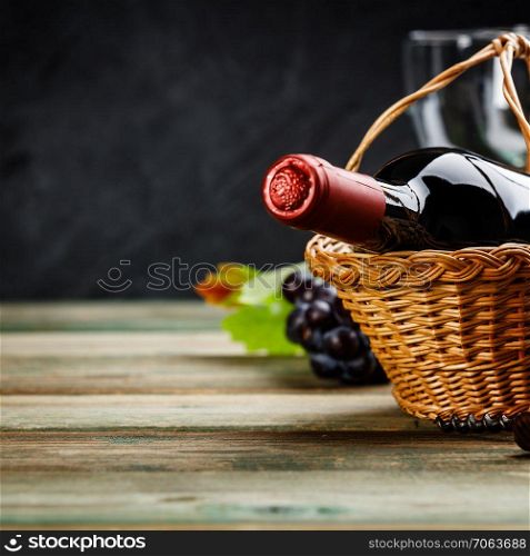 Wine composition on dark rustic background, space for text