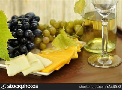 wine composition with cheese and grape close up