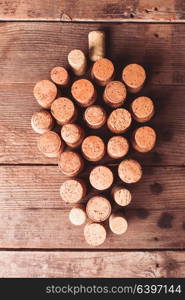 Wine corks on wooden backgroud as a grape shape fruit. Wine corks on table