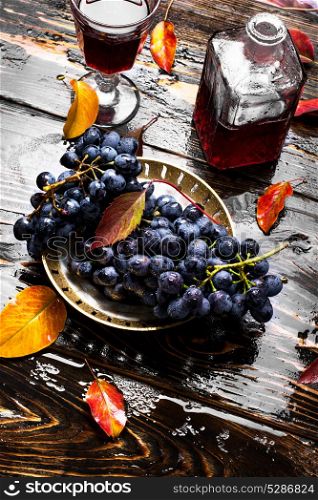 Wine from autumn grapes. glass and a decanter with red wine from autumn grapes