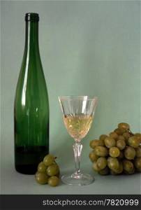 Wine,glass and frapes isolated on green background