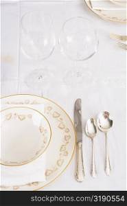 Wine glasses with plates and cutleries on a dining table