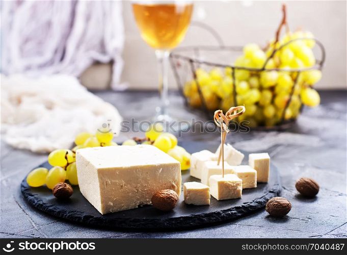 wine,grape and cheese on a table