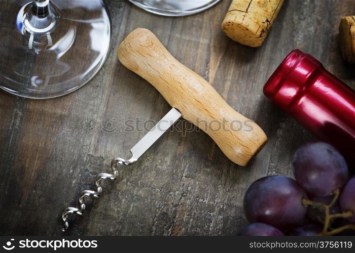 Wine,grape, glasses and corkscrew on wooden background
