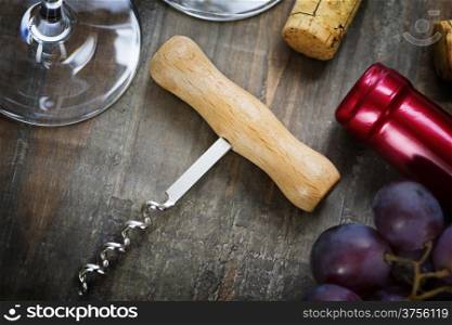Wine,grape, glasses and corkscrew on wooden background