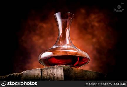 Wine in a decanter on a wooden table. Wine in a decanter