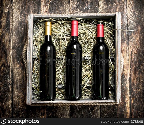Wine in the box. On a wooden background.. Wine in the box.
