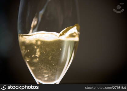 Wine is being poured to a glass from a bottle