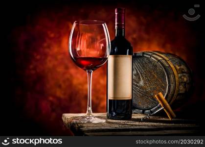 Wine on a wooden table in dark colors. Wine and barrel on a table