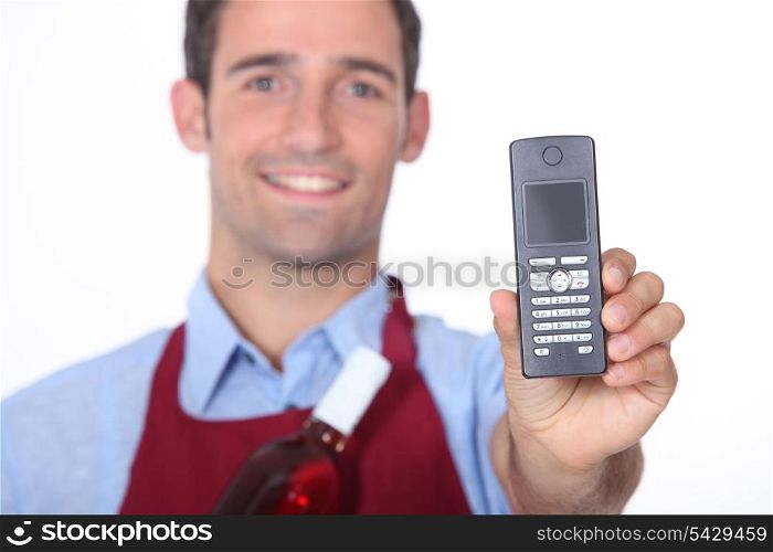 Wine waitor showing mobile phone
