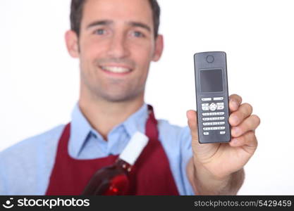 Wine waitor showing mobile phone