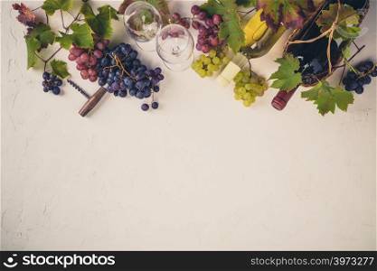 Wine with glasses, grapes, leaves and corkscrew on dark background, copyspace, flat lay. Wine composition on rustic background - space for text