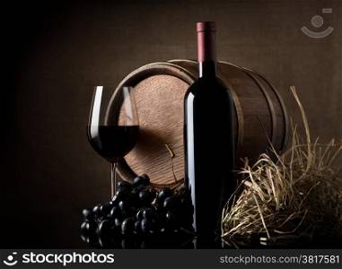 Wine with grape and barrel on brown background