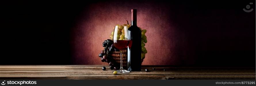 Wine with grape in basket on a vinous background