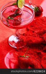 wine with strawberries and lime. Martini glass with strawberries and red lace