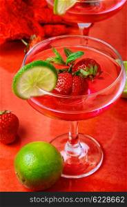 wine with strawberries and lime. Martini glass with strawberries and red lace