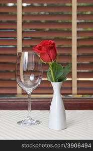 wineglass and rose on the table