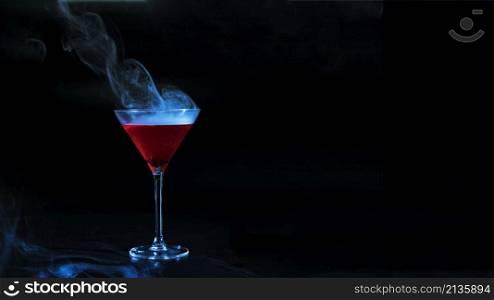 wineglass with red smoky liquid