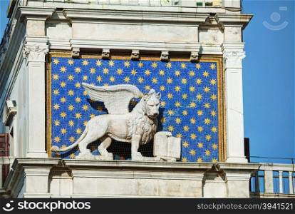 Winged lion on facede of the bell tower at San Marco square in Venice, Italy