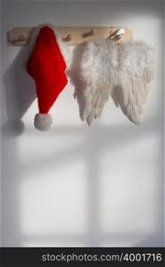 Wings and santas hat hanging on a hook