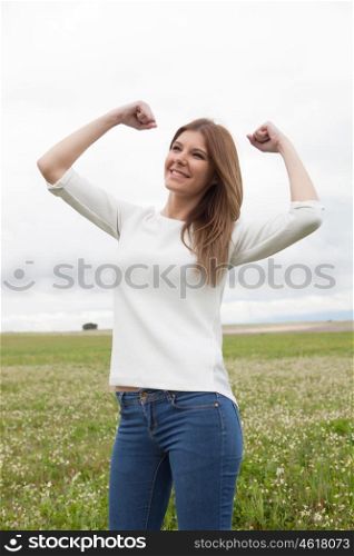 Winner girl in the meadow celebrating the success